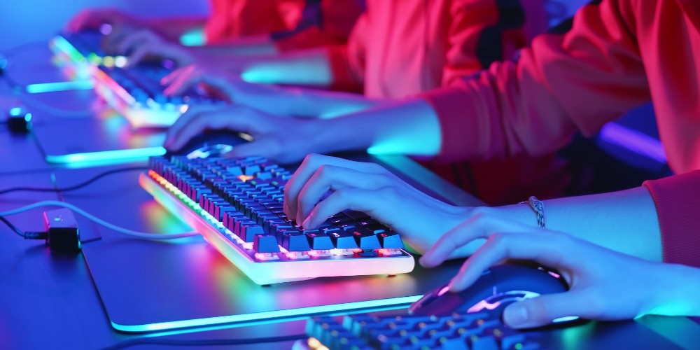 hands-of-gamers-using-computer-mouse-and-keyboards-on-table